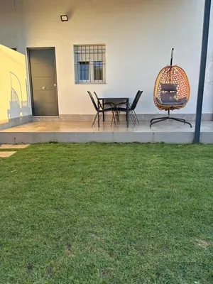 a patio with a table and chairs in a yard at Ohana in Conil de la Frontera