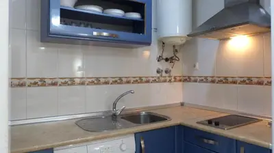 a small kitchen with a sink and a microwave at fantástico apartamento chipiona in Chipiona