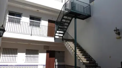 a spiral staircase in a building with windows at fantástico apartamento chipiona in Chipiona
