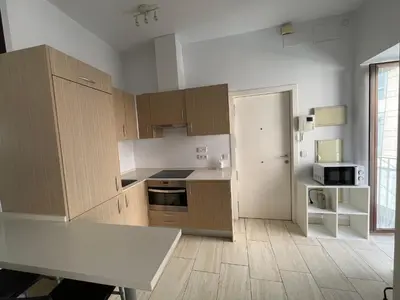 a kitchen with wooden cabinets and a white counter top at Apartamento en pleno centro de Jerez de la Frontera in Jerez de la Frontera