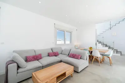 a living room with a couch and a table at Elena Sea Villa in Poblado de Sancti Petri
