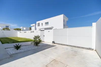 a white fence in front of a white house at Elena Sea Villa in Poblado de Sancti Petri