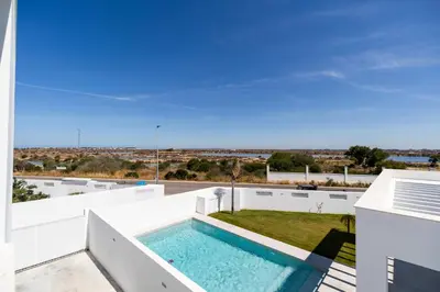 a swimming pool on the roof of a house at Elena Sea Villa in Poblado de Sancti Petri