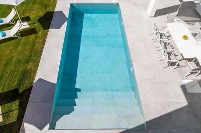 an overhead view of a swimming pool with chairs at Elena Sea Villa in Poblado de Sancti Petri