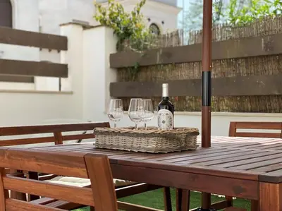 a table with two wine glasses and a bottle of wine at Casa Playa la Jara in Sanlúcar de Barrameda