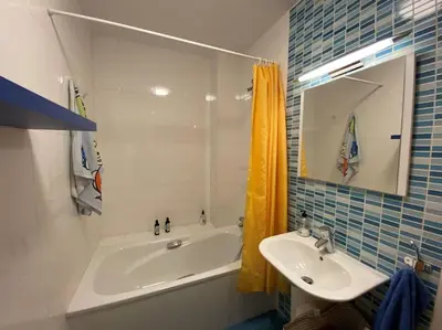 a bathroom with a sink and a bath tub and a sink at Casa Playa la Jara in Sanlúcar de Barrameda