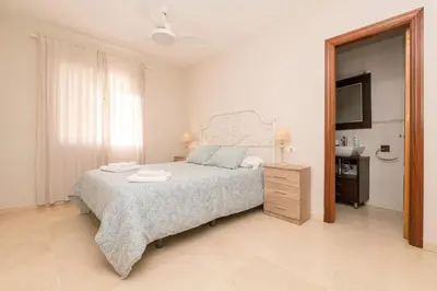 a bedroom with a bed and a sink and a mirror at Carmen Viejo in Sanlúcar de Barrameda
