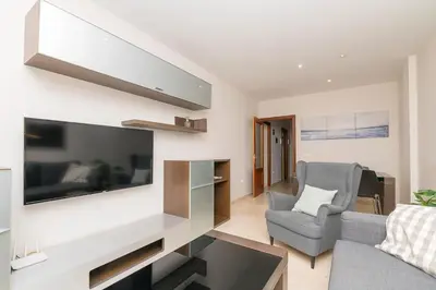 a living room with a large flat screen tv on a wall at Carmen Viejo in Sanlúcar de Barrameda