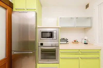 a kitchen with a refrigerator and a microwave at Carmen Viejo in Sanlúcar de Barrameda