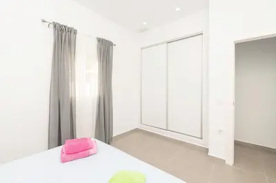 a bedroom with a bed and a mirror and a table at Miamar 2 in Hozanejos