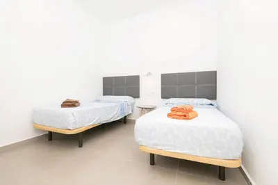 a white bedroom with a pink box on a bed at Miamar 2 in Hozanejos