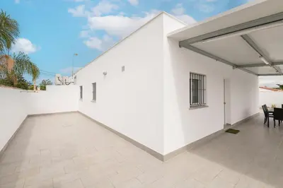 a white house with a white wall and a patio at Miamar 2 in Hozanejos