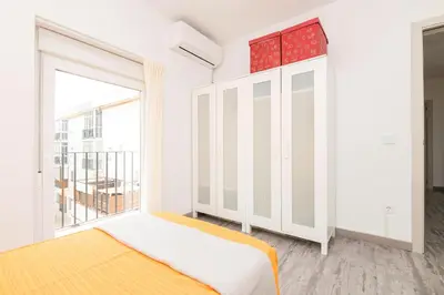 a bedroom with a bed and a large window at La Isleña in San Fernando
