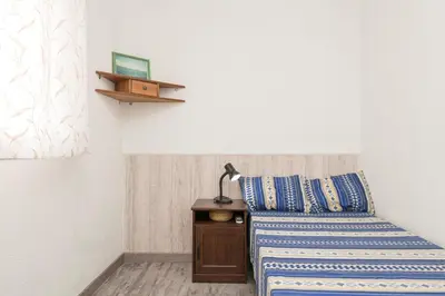 a bedroom with a bed and a lamp on a night stand at La Isleña in San Fernando