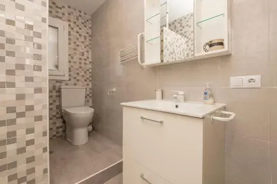 a bathroom with a white sink and a toilet at La Isleña in San Fernando