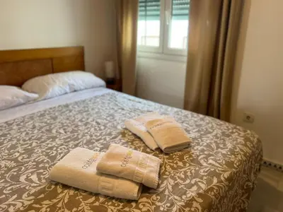 two towels are sitting on top of a bed at La Barrosa in Novo Sancti Petri