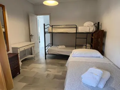 a room with two bunk beds and a hallway at La Barrosa in Novo Sancti Petri