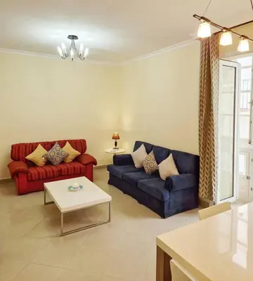 a living room with two couches and a table at Roy's Cadiz Inn in Cádiz