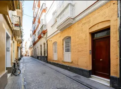 an empty street with a bike parked next to a building at Roy's Cadiz Inn in Cádiz