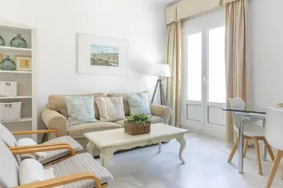 a living room with a couch and a table at Apartamento con terraza en Playa de Regla. 6. in Chipiona