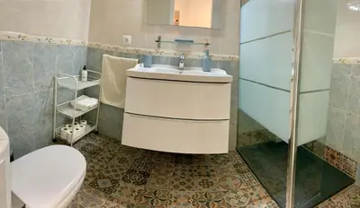 a bathroom with a white sink and a toilet at Apartamento La Paz in Sanlúcar de Barrameda