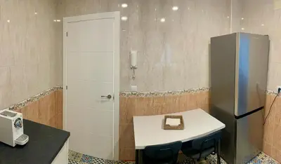 a bathroom with a white table and a refrigerator at Apartamento La Paz in Sanlúcar de Barrameda
