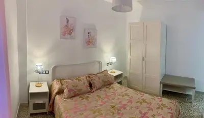 a bedroom with a bed and two night stands at Apartamento La Paz in Sanlúcar de Barrameda