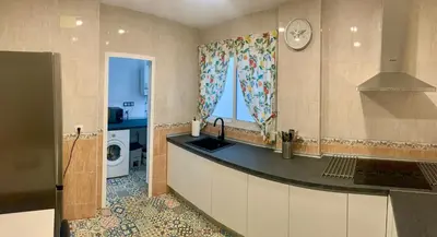 a kitchen with a sink and a washing machine at Apartamento La Paz in Sanlúcar de Barrameda