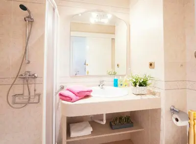 a bathroom with a sink and a shower and a mirror at Summerlandrota La Caleta in Rota