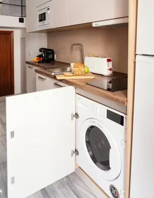 a kitchen with a washing machine in a kitchen at Summerlandrota Veracruz28 in Rota