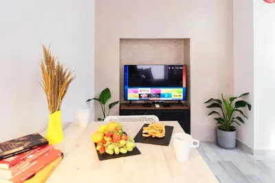 a living room with a table with fruit and a tv at Summerlandrota Veracruz28 in Rota