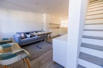 a living room with a couch and a table at GuestReady - La Ostra in Novo Sancti Petri