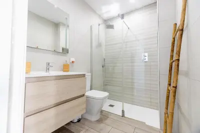 a bathroom with a shower and a toilet and a sink at GuestReady - La Ostra in Novo Sancti Petri