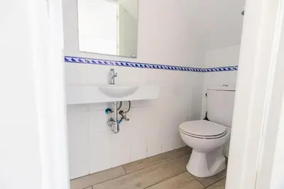 a bathroom with a toilet and a sink at GuestReady - La Ostra in Novo Sancti Petri