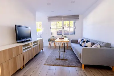 a living room with a couch and a tv at GuestReady - La Ostra in Novo Sancti Petri