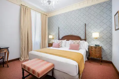 a bedroom with a large white bed with pink pillows at Soho Boutique Duques de Medinaceli - Adults Recommended in El Puerto de Santa María