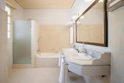 a bathroom with a sink and a mirror and a tub at Soho Boutique Duques de Medinaceli - Adults Recommended in El Puerto de Santa María