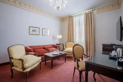 a living room with a red couch and chairs at Soho Boutique Duques de Medinaceli - Adults Recommended in El Puerto de Santa María