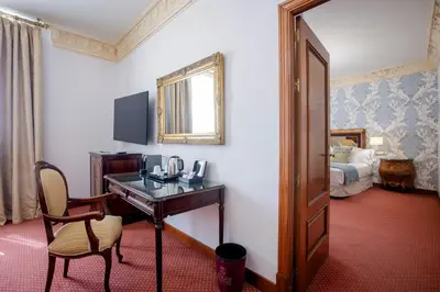 a hotel room with a desk and a bed at Soho Boutique Duques de Medinaceli - Adults Recommended in El Puerto de Santa María