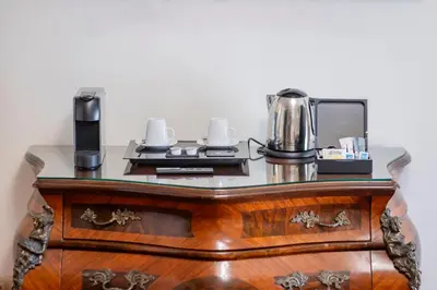 a dresser with a coffee maker on top of it at Soho Boutique Duques de Medinaceli - Adults Recommended in El Puerto de Santa María