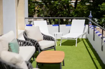 a group of chairs and tables on a balcony at Soho Boutique Duques de Medinaceli - Adults Recommended in El Puerto de Santa María