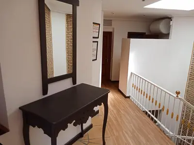 a black table in a hallway with a staircase at Apartamentos Jasmund - Bungalow 119 in San Fernando