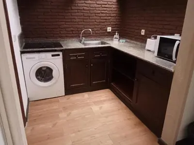 a kitchen with a sink and a washing machine at Apartamentos Jasmund - Bungalow 119 in San Fernando