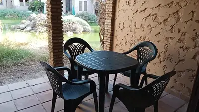 a table and four chairs on a patio at Apartamentos Jasmund - Bungalow 119 in San Fernando