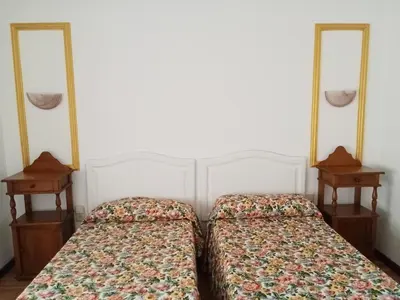 two beds in a room with two mirrors at Apartamentos Jasmund - Bungalow 119 in San Fernando