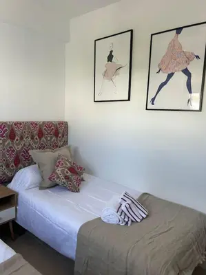 a room with a bed and pictures on the wall at Novo Sancti Petri in Cádiz
