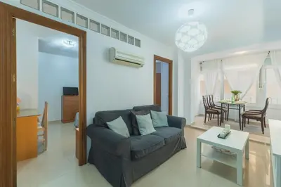 a living room with a couch and a table at Disfruta Vacaciones Familiares Piso Frente al Mar in Cádiz