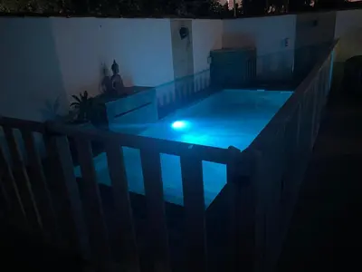 a swimming pool in a house at night at Chalet con piscina in Chiclana de la Frontera