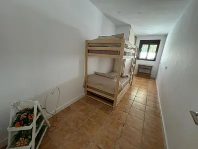 a hallway with a room with bunk beds in it at Chalet con piscina in Chiclana de la Frontera