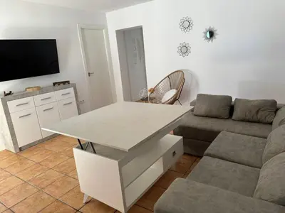 a living room with a couch and a table at Chalet con piscina in Chiclana de la Frontera